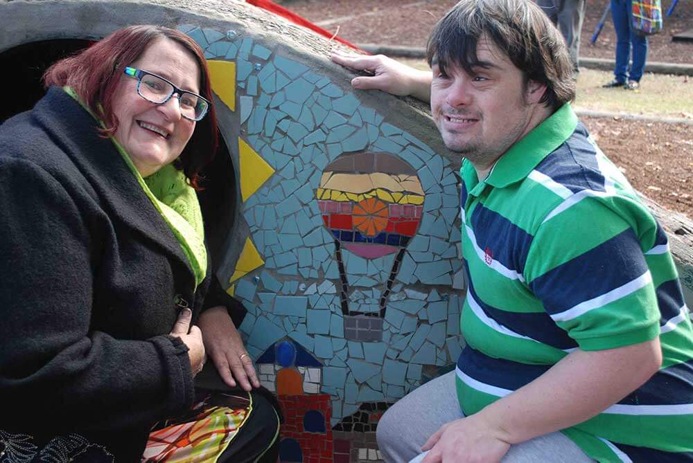 Wendy Lenthen and Jason Benedet with their flying machines mosaic in Hinkler Park playground